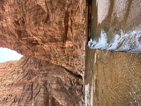 Rocky gorge with a small stream flowing through it.