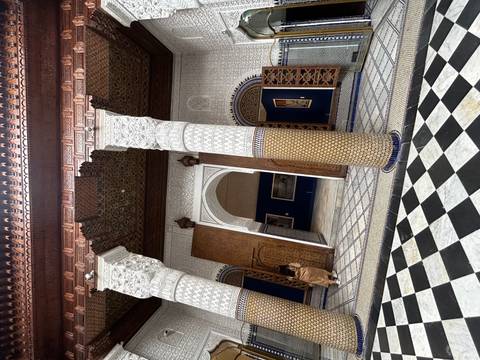       Interior of a decorated architectural building with columns.
  