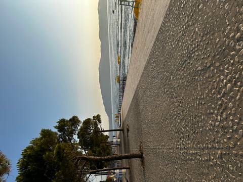       Beachfront with a view of the sea and mountains.
  