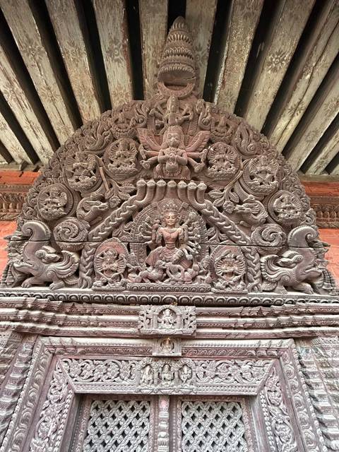       Intricate stone carving with religious symbols.
  