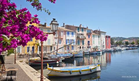Colorful houses along a harbor with boats, with an overlay text.