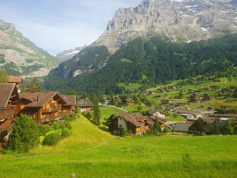 A picturesque village nestled in lush green mountains.