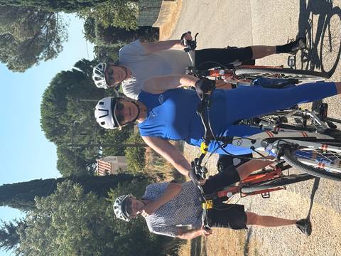 Cyclists taking a break on a rural road.