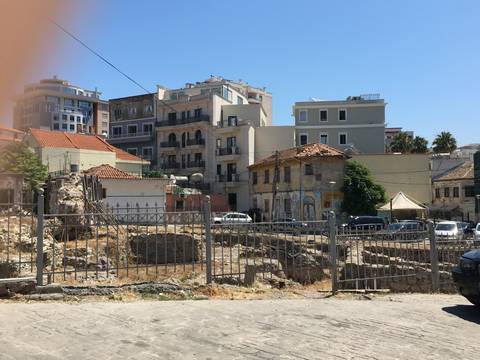 Cityscape with various residential and commercial buildings.