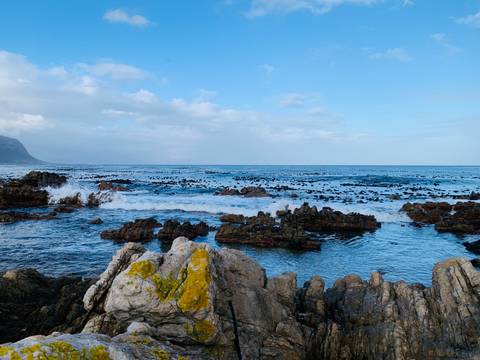 Rocky coastline with ocean waves crashing onto the rocks.