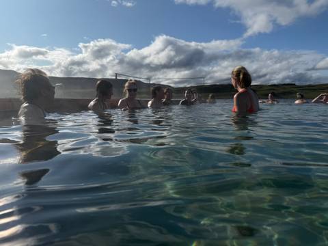 Group of people relaxing in a hot spring pool.