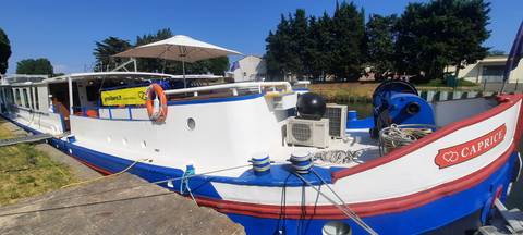 Docked tour boat with colorful accents.
