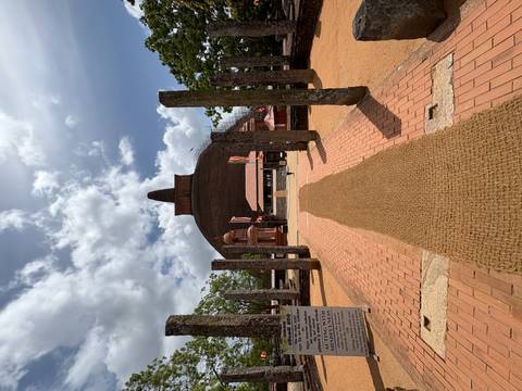 A large stupa with flags and visitors in the foreground.