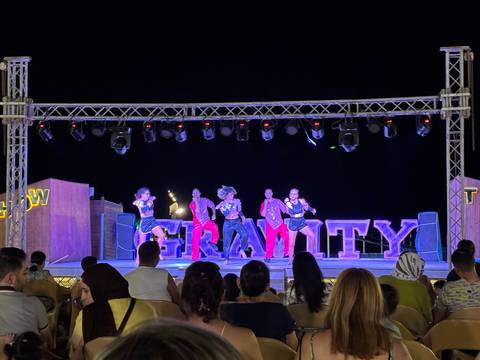 Night performance on stage with audience.