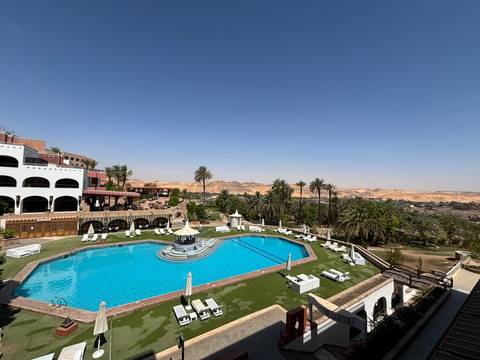 Resort with a pool and desert landscape.