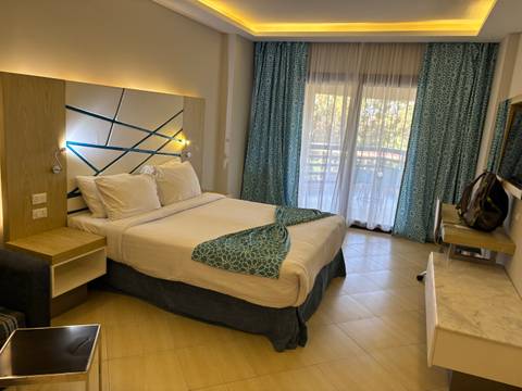 Cozy hotel room interior with balcony view.