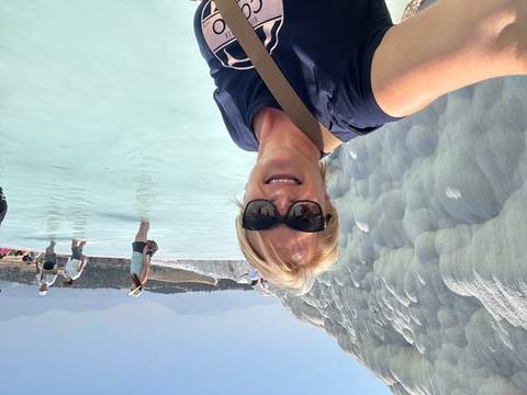 Person taking a selfie at Pamukkale thermal pools.