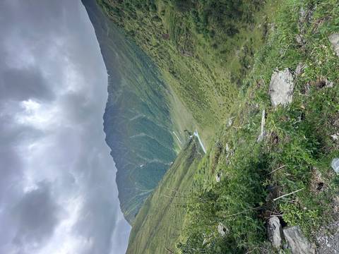Green valley with a small river running through the mountains.