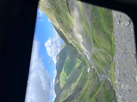 Expansive mountain landscape with a winding road.