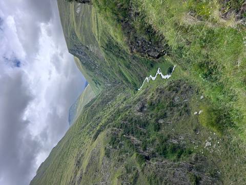       Deep mountain valley with a flowing river.
  