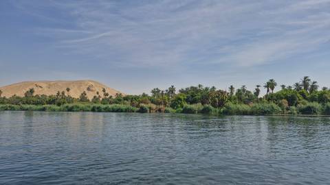 Scenic view of the Nile River with lush greenery.