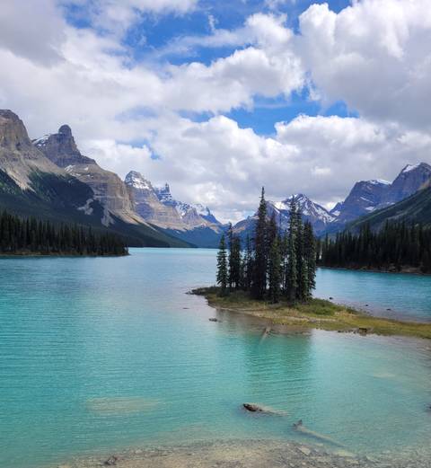       Beautiful turquoise lake surrounded by snow-capped mountains.
  