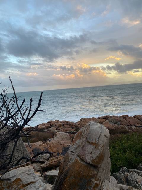       Rocky coastal landscape under a cloudy sky.
  
