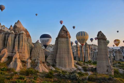 Hot air balloons floating over Cappadocia's unique rock formations.
