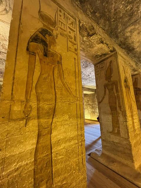 Interior with ancient Egyptian hieroglyphics and paintings on walls.