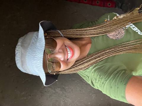       Person smiling wearing a hat and sunglasses indoors.
  