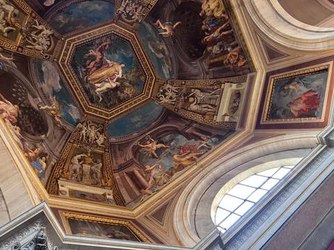 Intricately painted ceiling with religious and historical imagery.
