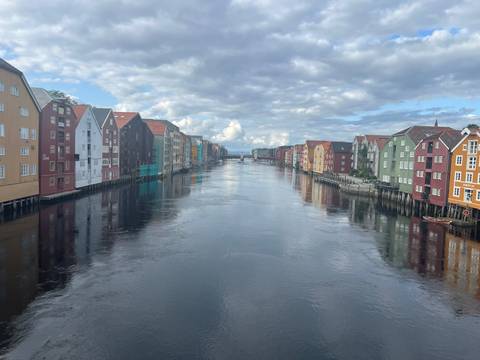       Colorful waterfront buildings along a river.
  