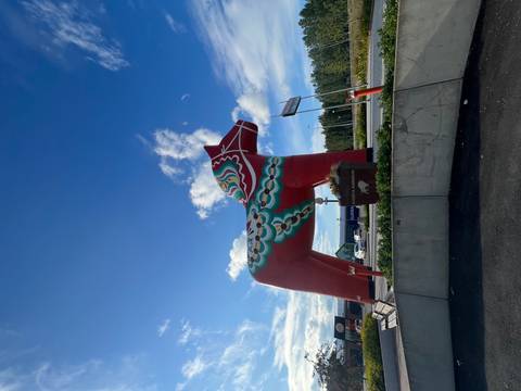       Large decorative Dala horse statue in a public area.
  