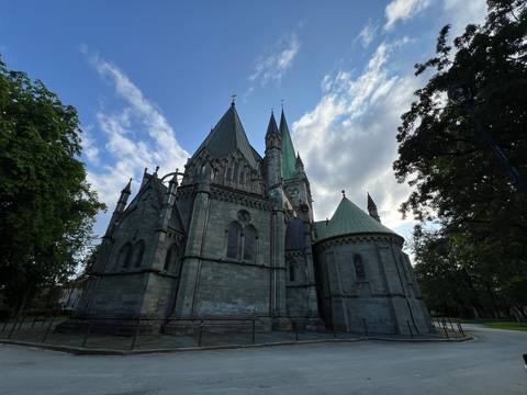       Historic cathedral with tall spires under a blue sky.
  