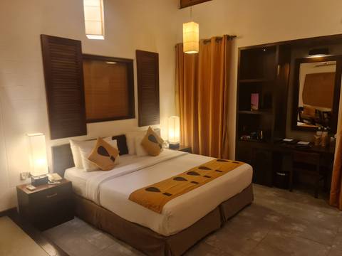       Interior of a cozy hotel room with double bed.
  