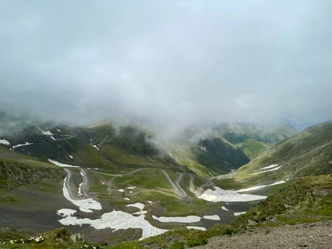 Winding roads in a foggy mountain landscape.