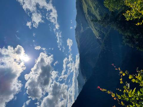       View of a mountainous landscape with a sunny sky.
  