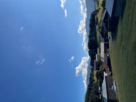       Rural village houses with blue sky and clouds in the background.
  