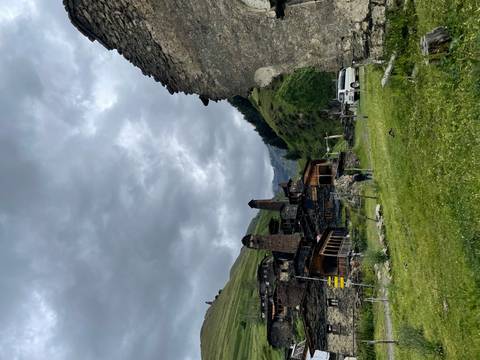       View of a rural village with mountainous background.
  