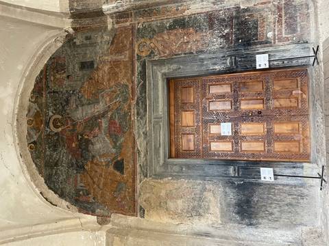 Ornate church door with religious fresco.