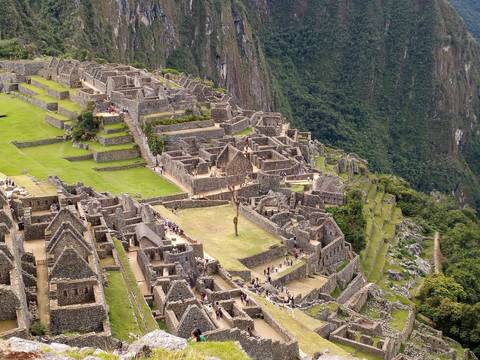 An aerial view of Machu Picchu with ancient ruins and lush landscape.