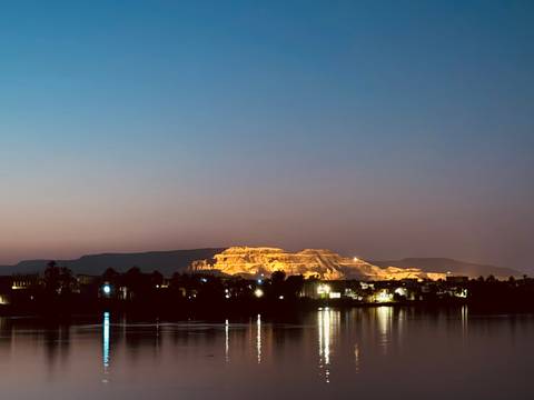       Landscape view of illuminated mountains at night.
  