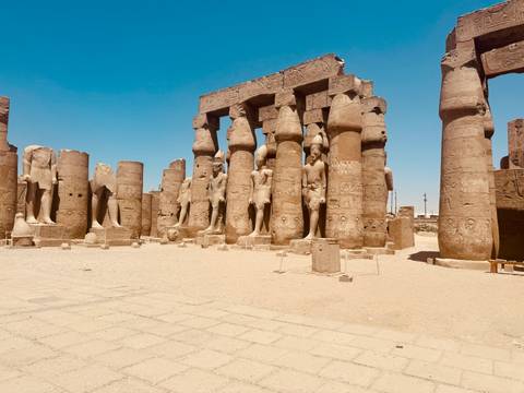       Ancient temple ruins with large columns and statues.
  