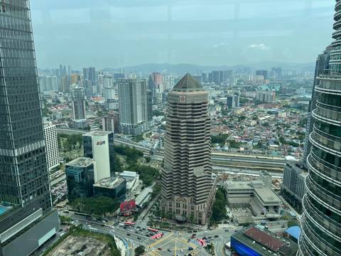       Skyscrapers and city landscape with a hazy sky.
  