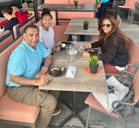 Group of people enjoying a meal at a restaurant with modern decor.