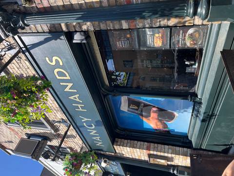 Nancy Hands pub front with Guinness advertisement.