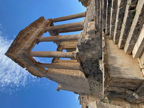 Ancient Roman-style ruins with columns and steps.