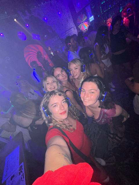 Group of people at a silent disco with headphones.