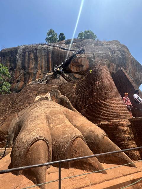       Visitors climbing up the rock fortress of Sigiriya.
  
