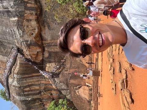       Tourist taking a selfie in front of Sigiriya rock.
  