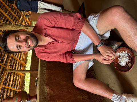       Person engaged in traditional cooking activity.
  