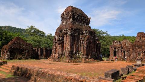 Ancient ruins and visitors in My Son Sanctuary.