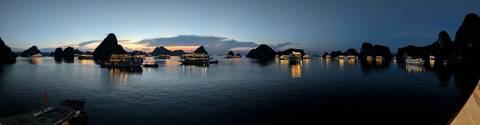 Evening view of boats in Halong Bay with scenic landscape.