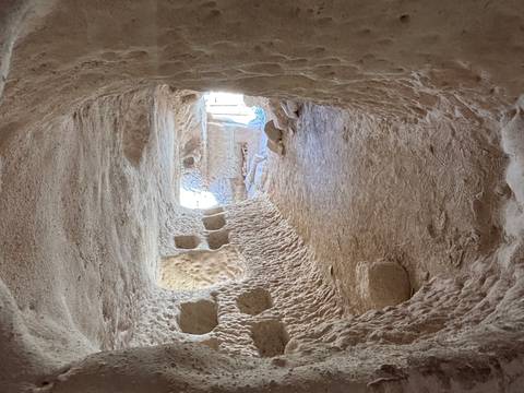       Interior of a cave with arch-shaped formations.
  