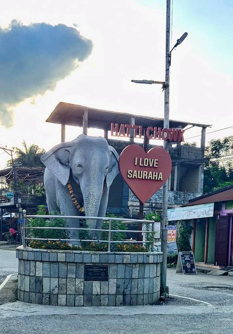       Statue of an elephant with a sign saying 'I Love Sauraha'.
  
